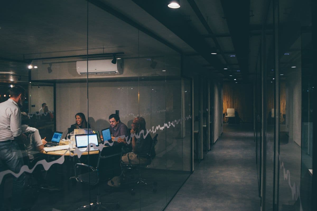Team collaborating in a glass-walled meeting room